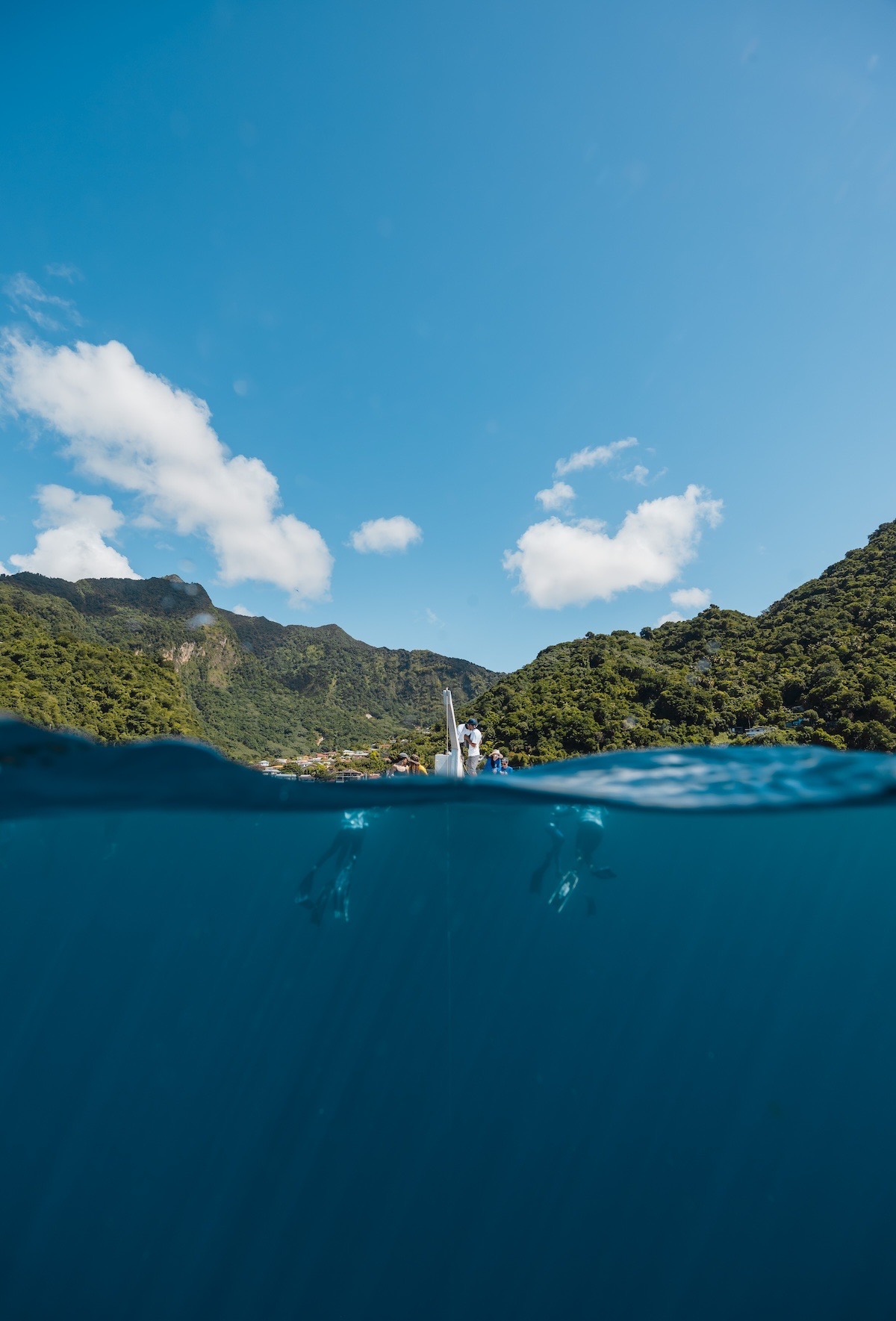 Divers and crew at the Blue Element platform in Soufrière Bay, split above and below the waterline