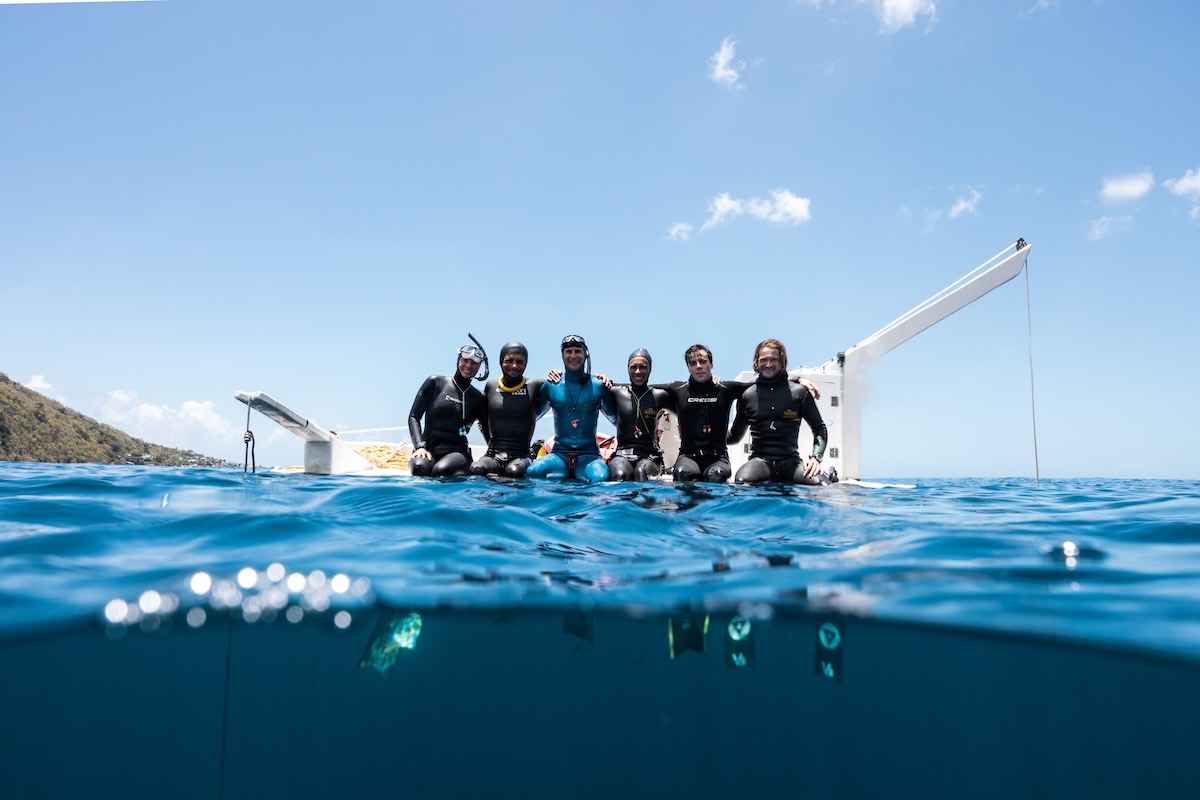 A depth-camp group together on the platform in Soufrière Bay