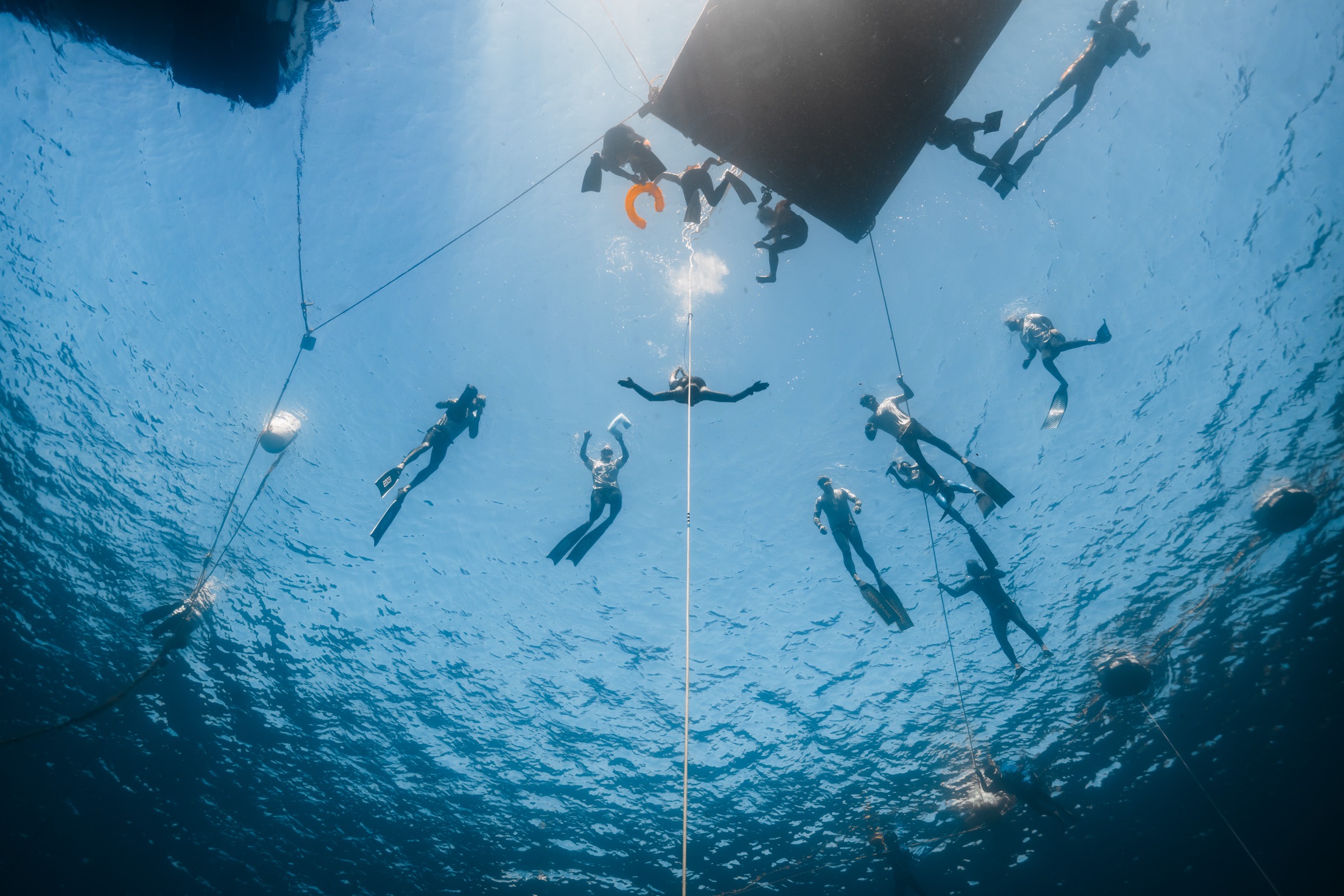The safety team and an athlete beneath the competition platform in Soufrière Bay