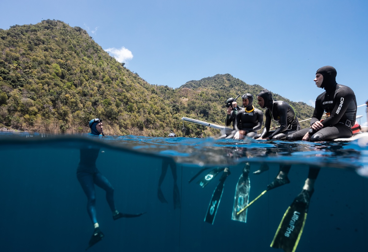 Freediving students at the surface beside a coach in Soufrière Bay