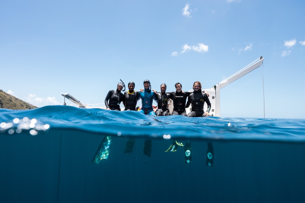 The deep camp crew sitting together on the platform edge