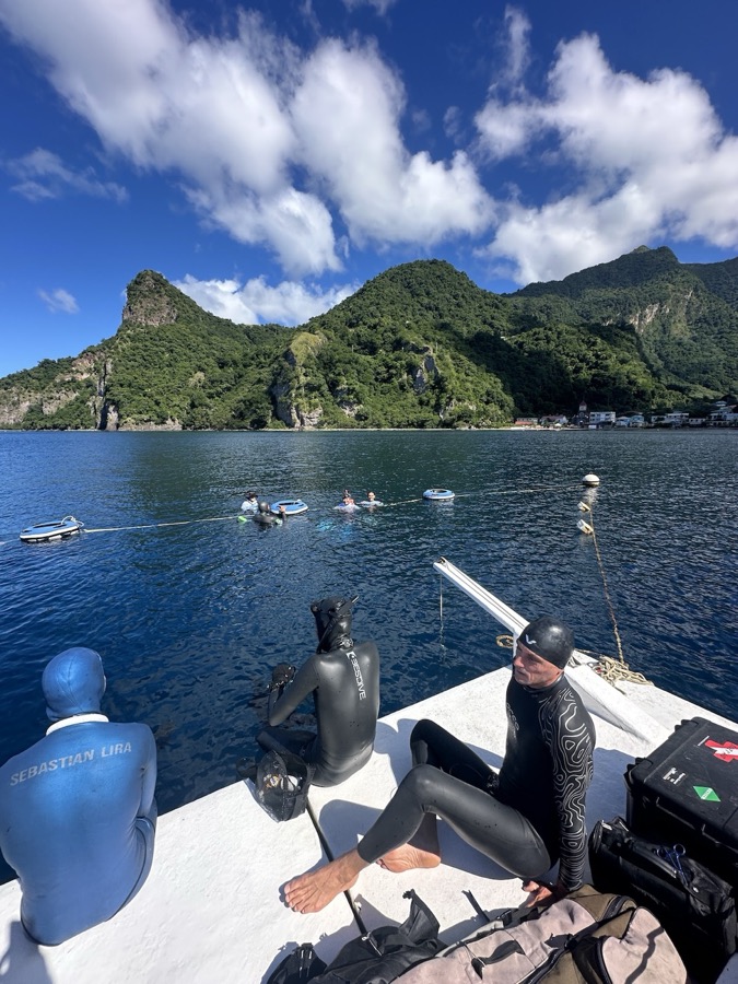 Record-holding freedivers resting on the boat deck between dives