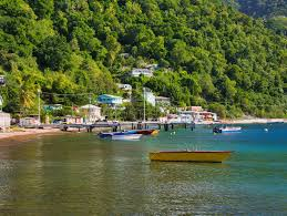 Fishing boats moored along the green shoreline of Soufrière